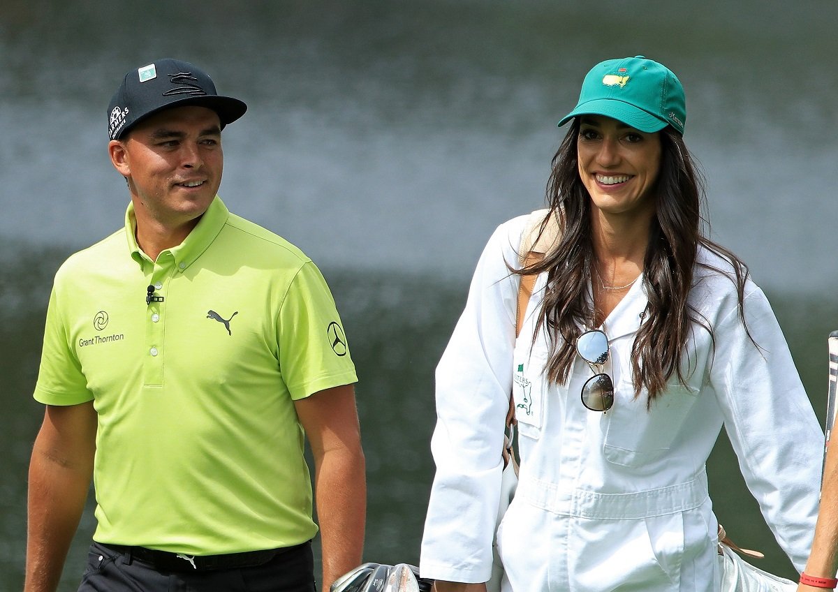 Golfer Rickie Fowler walking with wife Allison Stokke during the Par 3 Contest prior to the Masters at Augusta National Golf Club