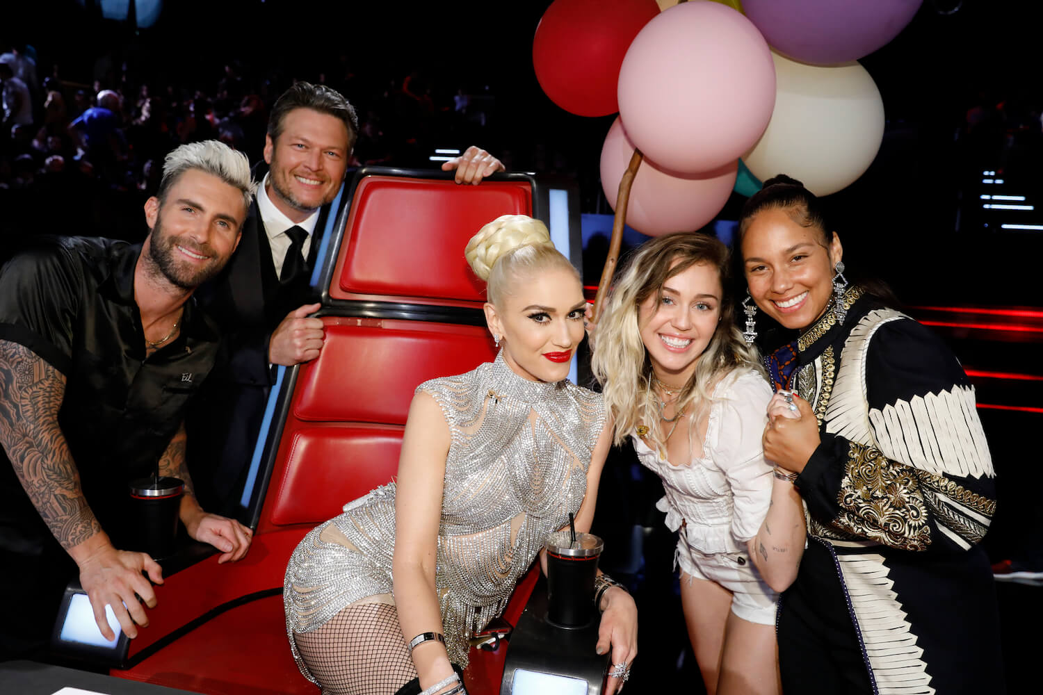 Gwen Stefani, Adam Levine, Blake Shelton, Miley Cyrus, and Alicia Keys smiling on 'The Voice'