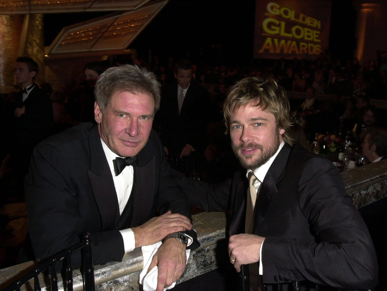 Harrison Ford and Brad Pitt in suits sitting across from each other