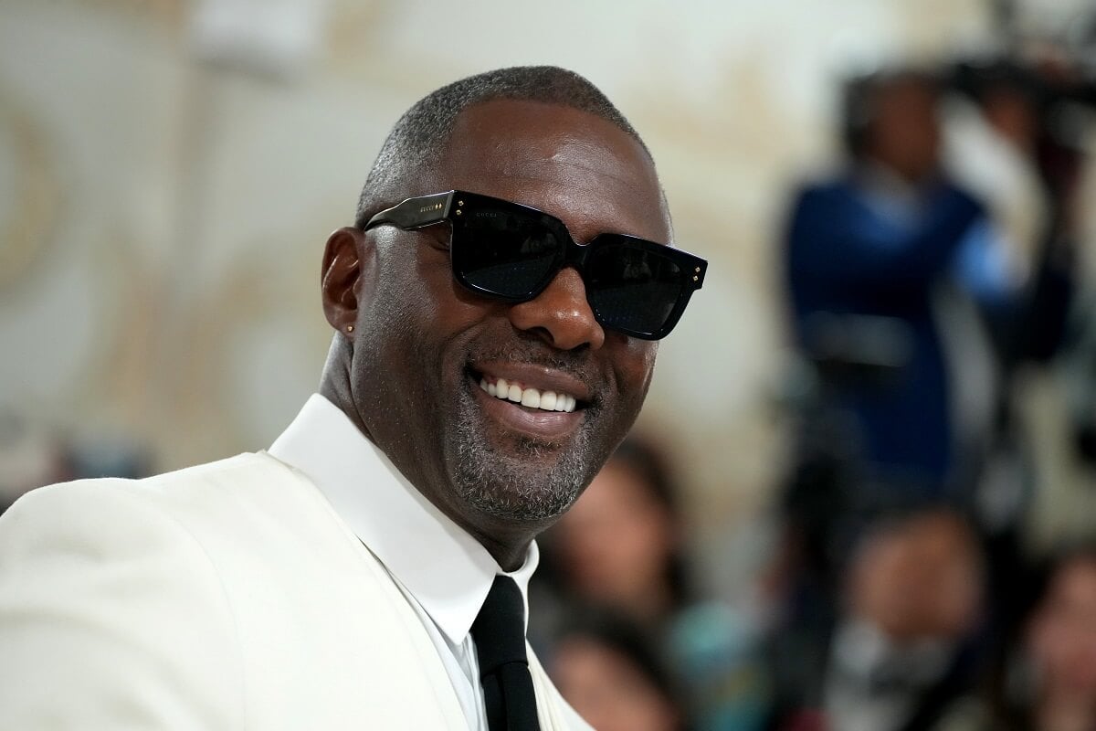 Idris Elba smiling while wearing sunglasses at the 2023 Met Gala.