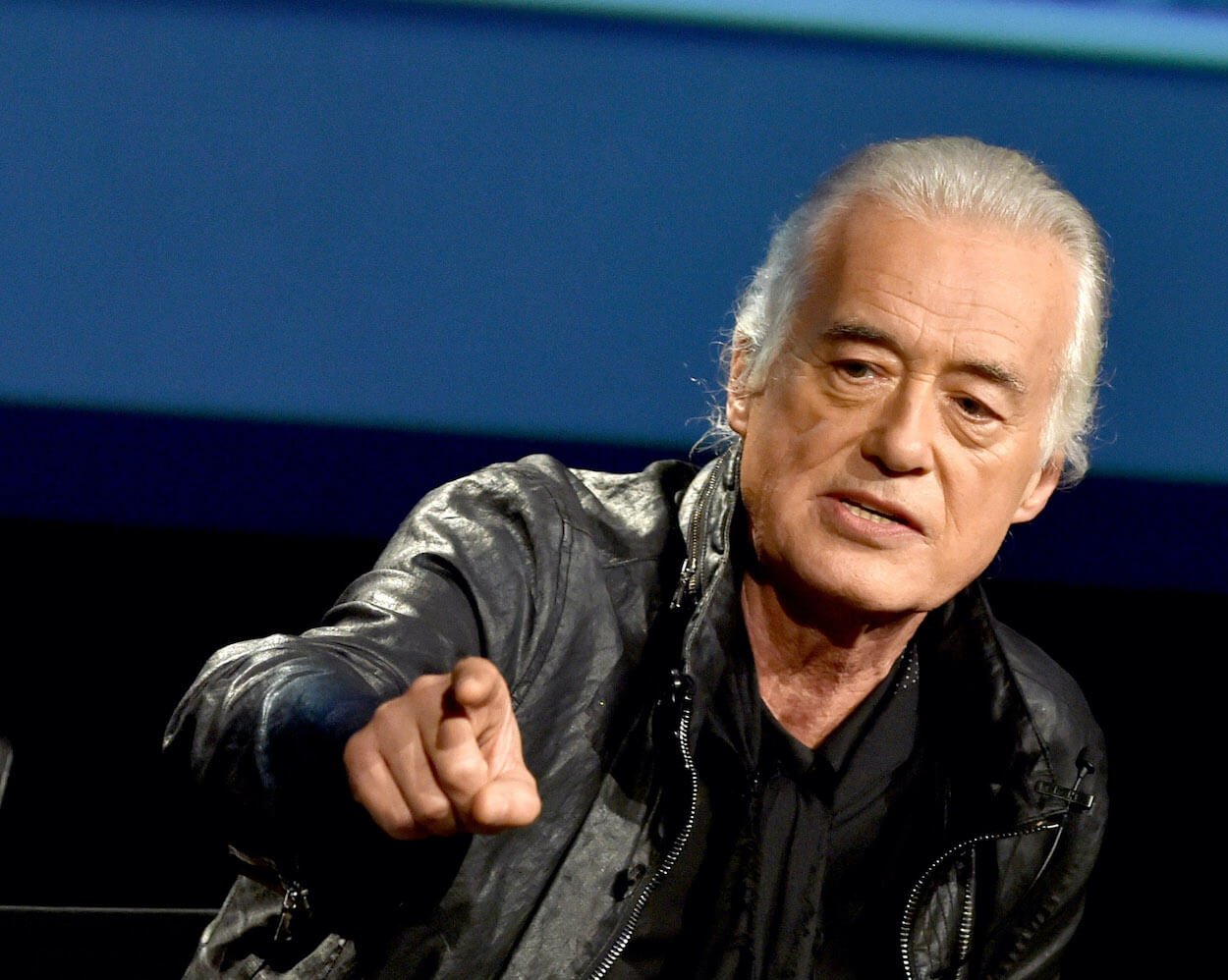 Led Zeppelin guitarist Jimmy Page wearing a leather jacket and pointing with his right hand during a 2014 appearance in Los Angeles.