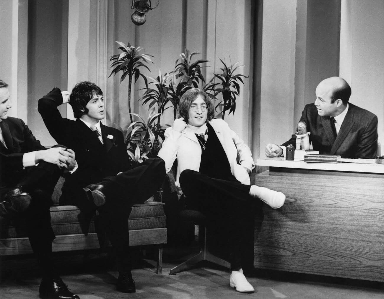 A black and white picture of Ed McMahon, Paul McCartney, John Lennon, and Joe Garagiola on the set of 
'The Tonight Show.'