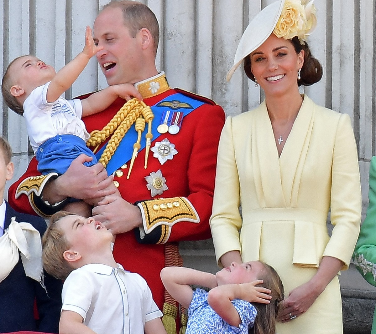 Kate Middleton and Prince William on the Buckingham Palace balcony with their children Prince George, Princess Charlotte, and Prince Louis, who the are hoping behave