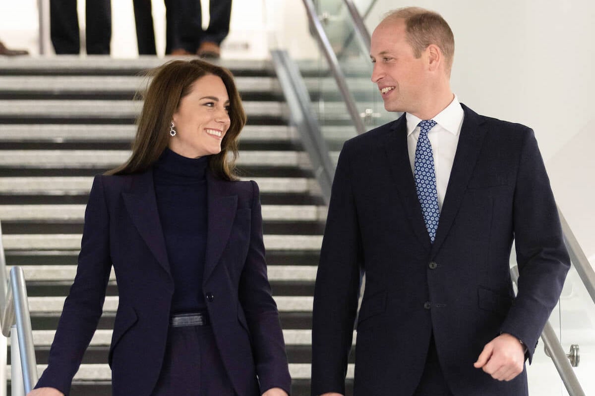 Kate Middleton and Prince William, whose lack of PDA is good, according to a body language expert, walk down a staircase