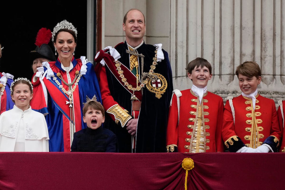 Kate Middleton and Prince William, whose parenting of Prince George may change when he turns 13, stand on the Buckingham Palace balcony with their children and other royals