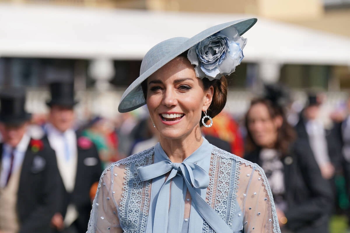 Kate Middleton, who a commentator says may avoid certain colors with what she wears to the 2023 Trooping the Colour, looks on wearing a blue dress and hat