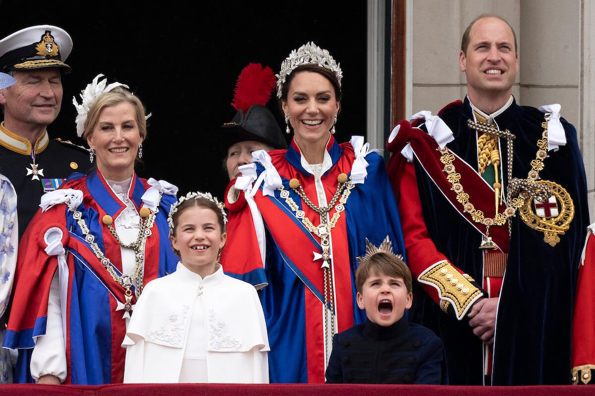 Kate Middleton, who, according to a body language expert uses one move to get Prince Louis to 'stay calm,' stands on the Buckingham Palace balcony with other royals