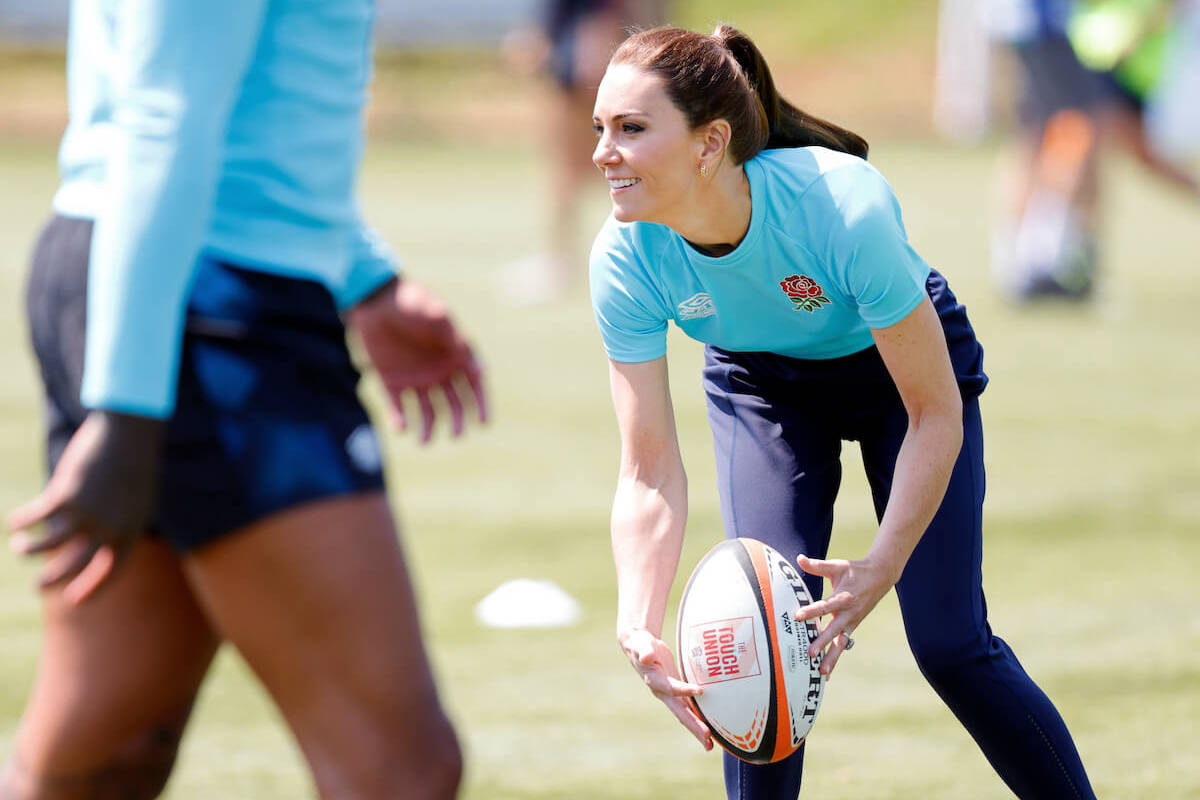 Kate Middleton, who resembled Princess Diana more than Queen Camilla playing rugby, according to a body language expert, looks on