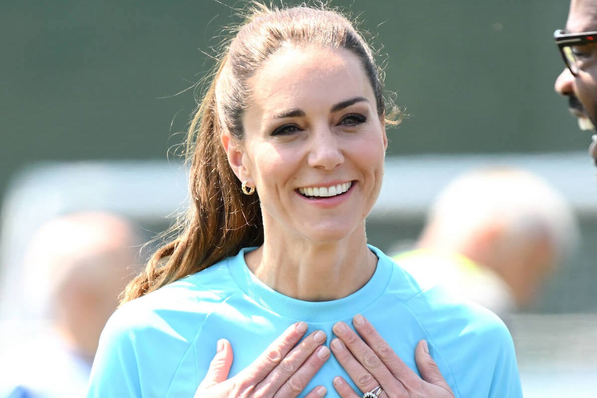 Kate Middleton, who resembled Princess Diana more than Queen Camilla playing rugby, according to a body language expert, smiles