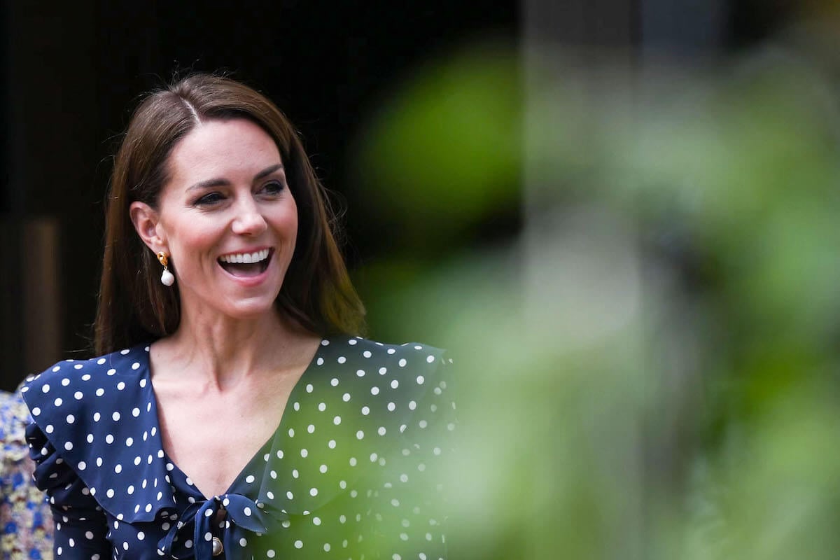 Kate Middleton, whom a body language expert says has the 'best royal smile,' smiles and looks on