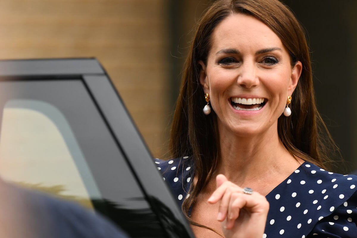 Kate Middleton, whose clothes have gone from 'businesslike' to more 'feminine' in 2023, smiles