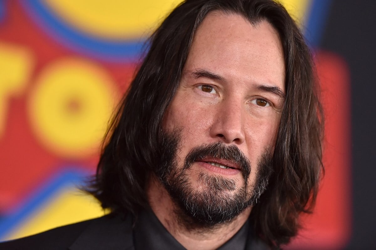 Keanu Reeves posing at the 'Toy Story 4' premiere in a suit.