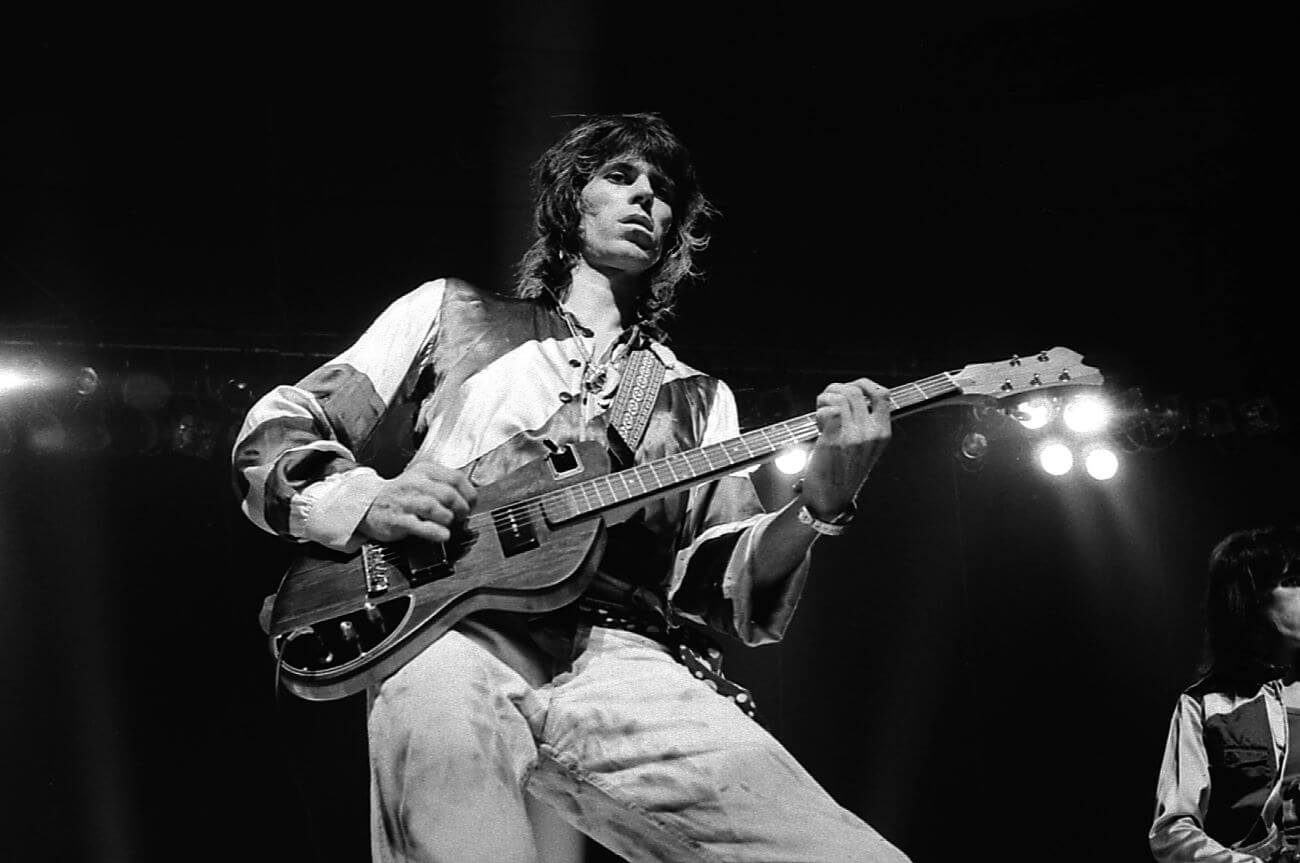A black and white picture of Keith Richards playing guitar.