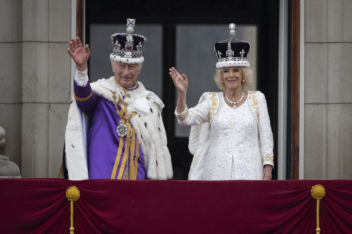 King Charles III and Queen Camilla are seen on the Buckingham Palace balcony during the flypast following the coronation ceremony