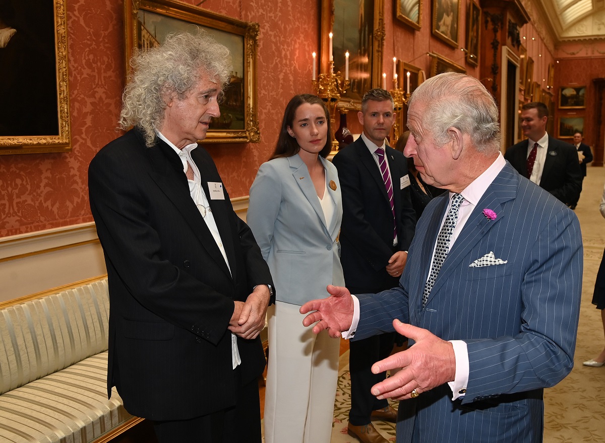 King Charles III, who uses a secret signal to get out of conversations, talking to astrophysicist and musician Brian May during a Space Sustainability Event at Buckingham Palace