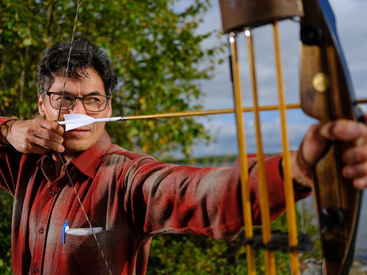 'Alone' Season 10 cast member Lee Ray DeWilde holding a bow and arrow