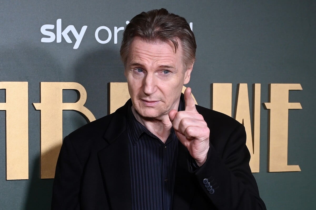 Liam Neeson posing in a suit at the premiere of 'Marlowe' in the UK.