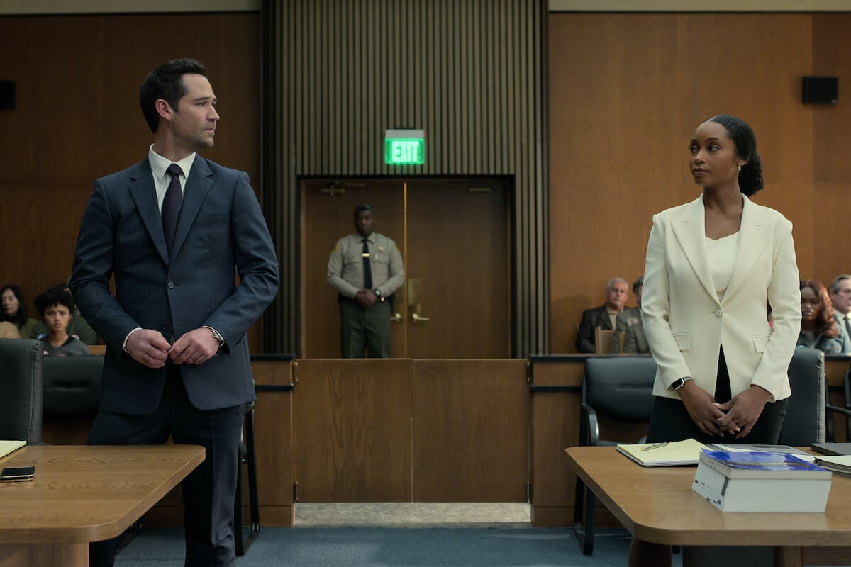 Manuel Garcia-Rulfo and Yaya DaCosta standing in a courtroom in 'The Lincoln Lawyer' Season 2