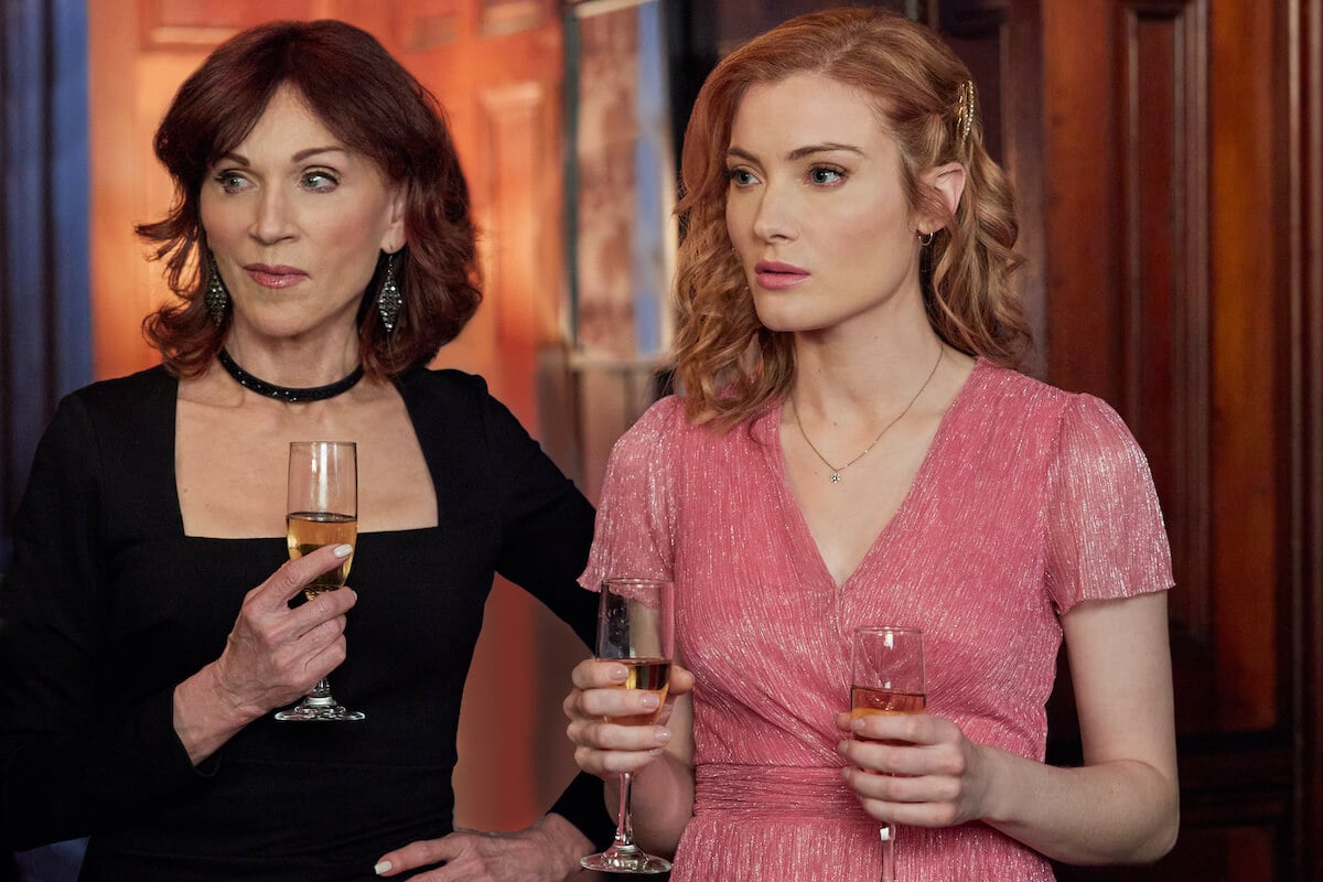 'Aurora Teagarden Mysteries: Something New' stars Marilu Henner and Skyler Samuels holding glasses of champagne.