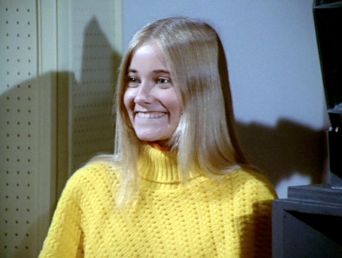 Maureen McCormick in a yellow turtleneck in 'The Brady Bunch'