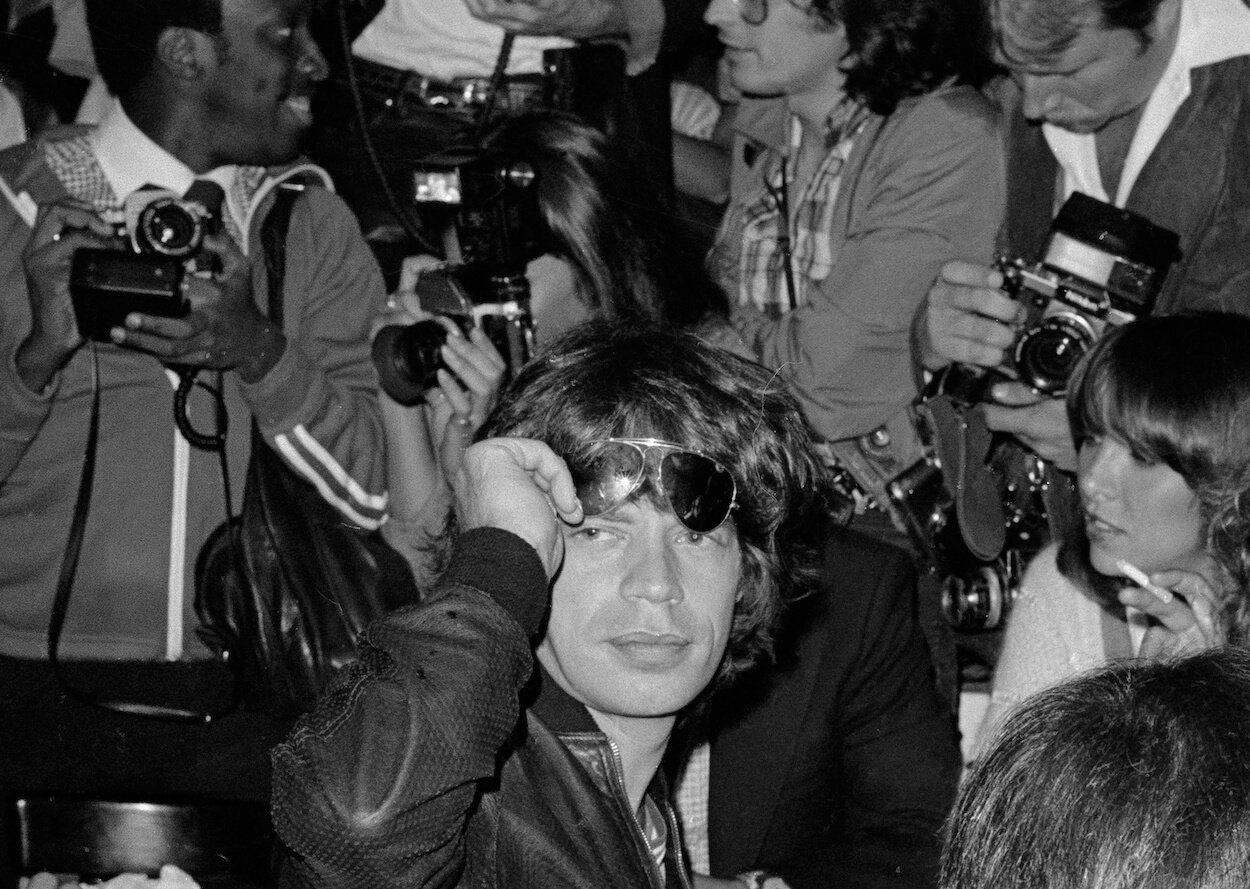 Mick Jagger raises his suglasses at a press reception for the release of The Rolling Stones album 'Some Girls.'