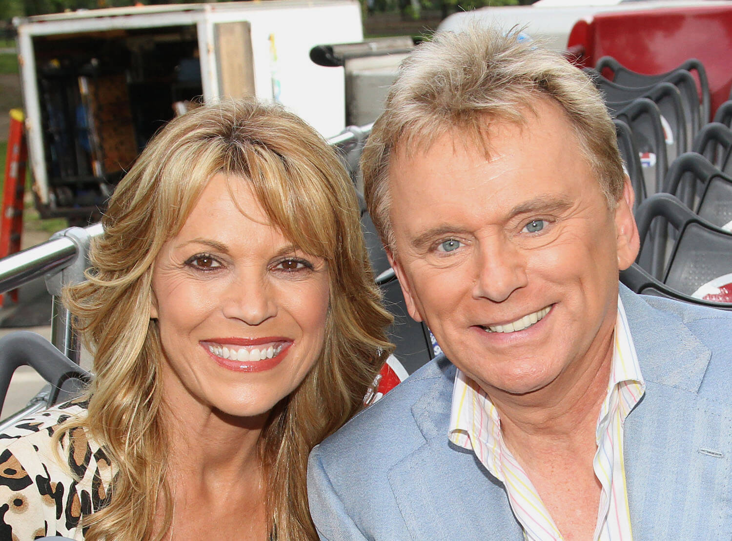 Pat Sajak and Vanna White from 'Wheel of Fortune' smiling while next to each other