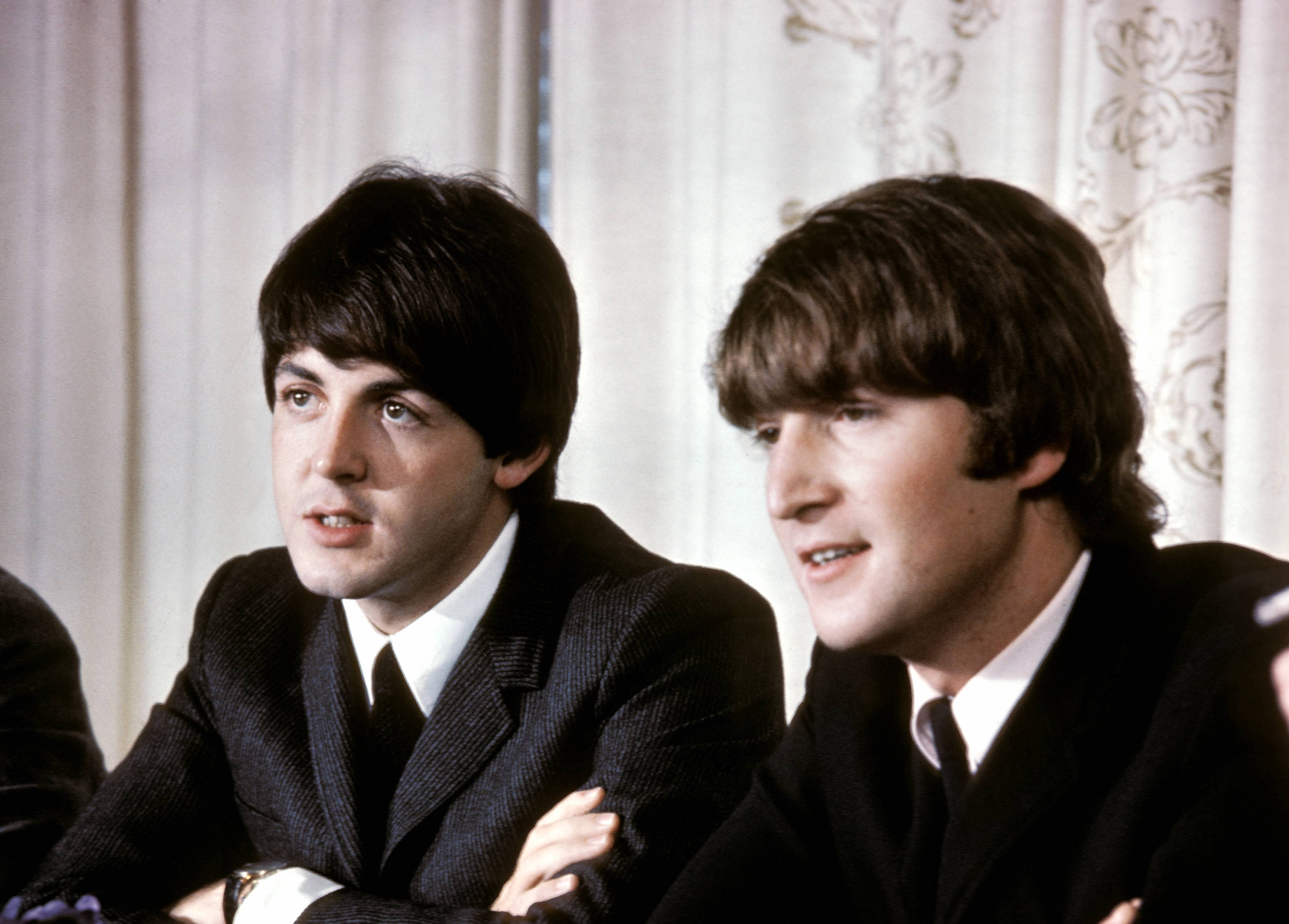 Paul McCartney and John Lennon of The Beatles at a press conference