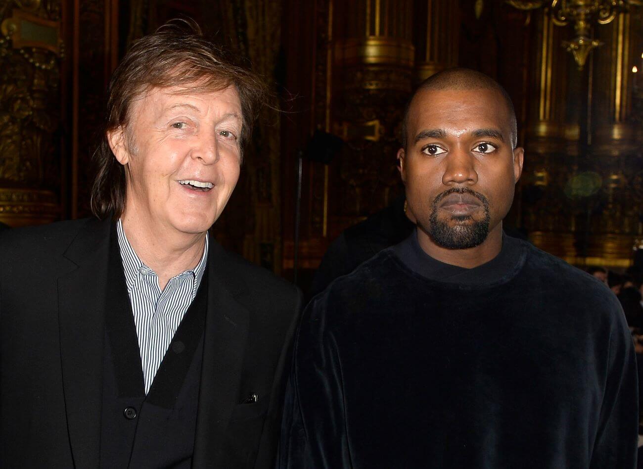Paul McCartney and Kanye West wear black jackets.