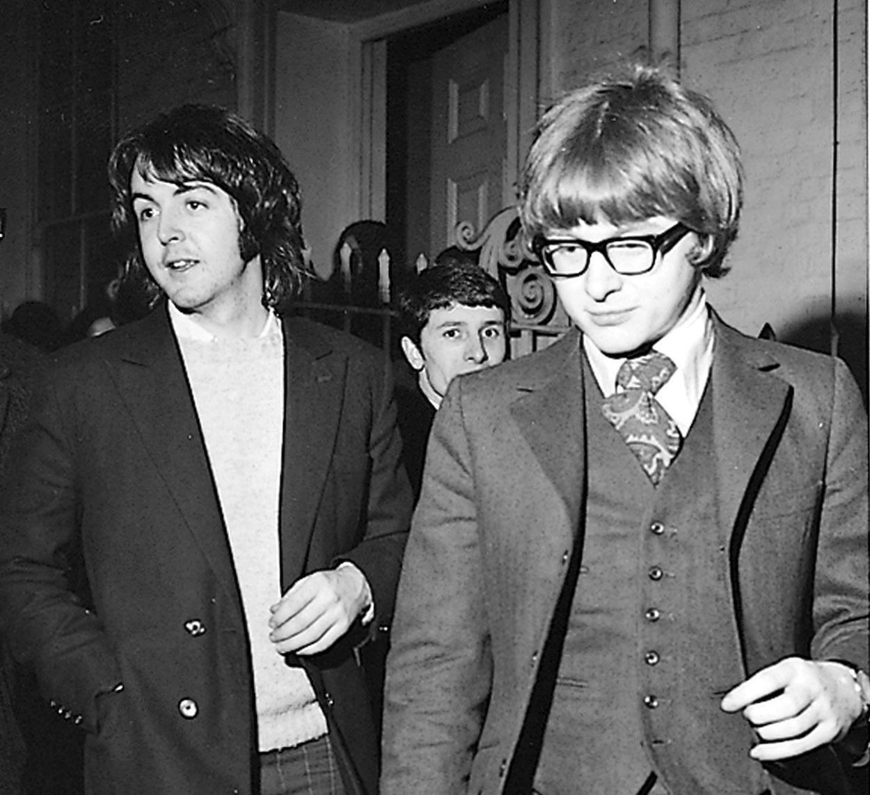 Paul McCartney (left) and Peter Asher walk together in 1969.