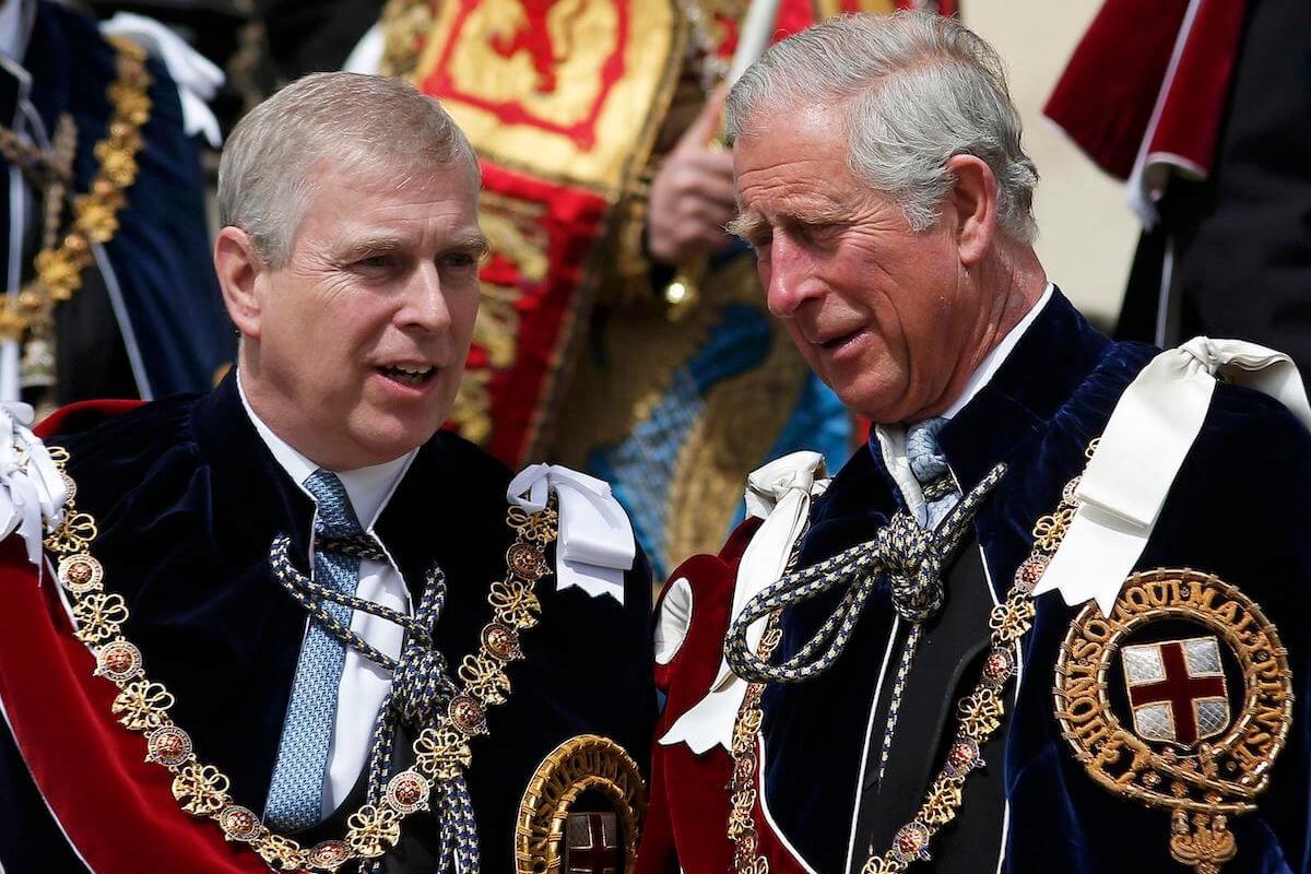 Prince Andrew, whose Order of the Garter honor King Charles won't take away, according to a commentator, stands next to King Charles