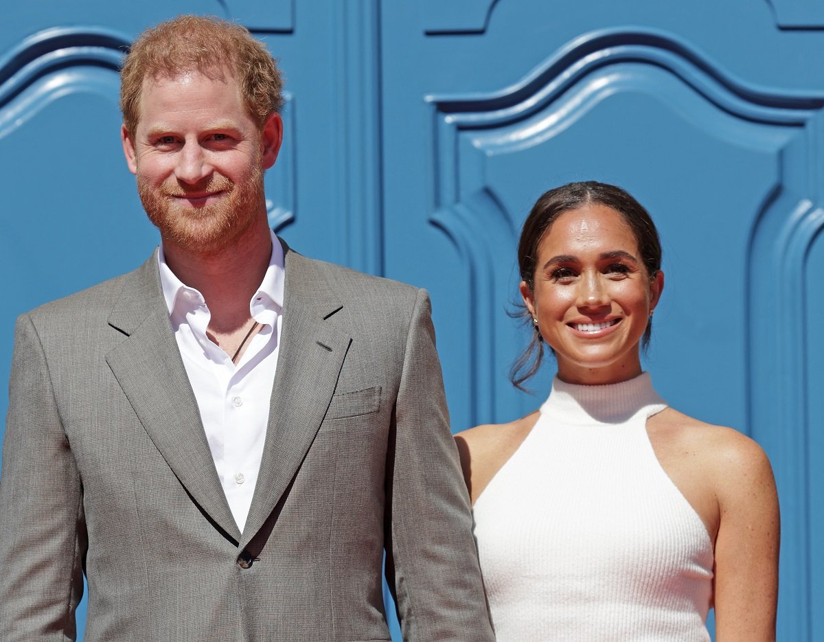 Prince Harry and Meghan Markle, who an expert says could change their surname to Spencer to align closer with Princess Diana's family, smile at town hall during the Invictus Games Dusseldorf 2023 events