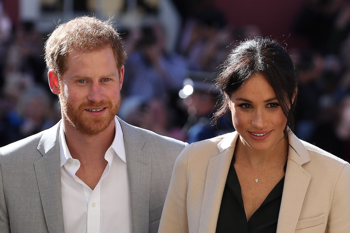 Prince Harry and Meghan Markle, whose first date took place on July 3, 2016, look on