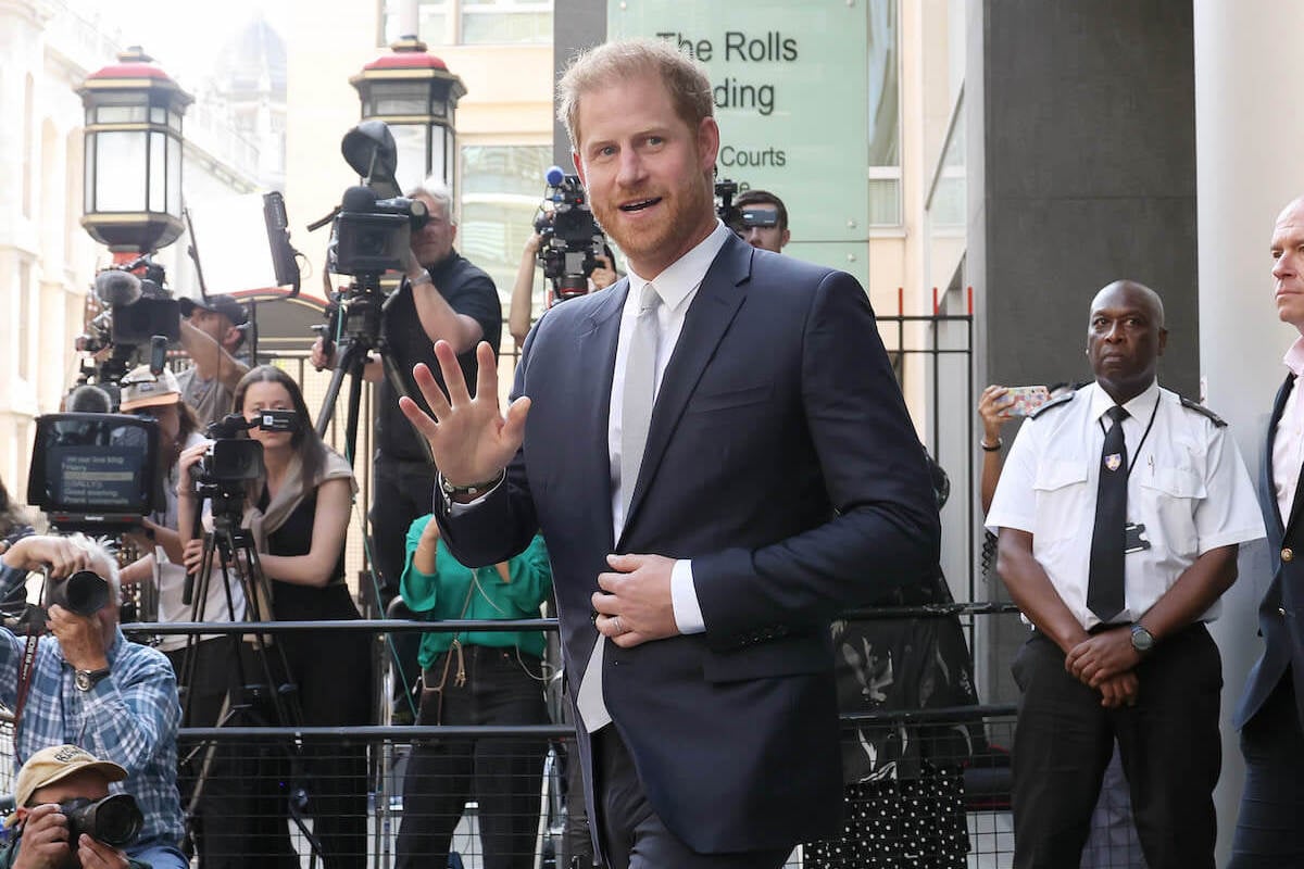 Prince Harry, who a phone hacking lawsuit win may not change British press, waves to crowds as he exits a London courthouse