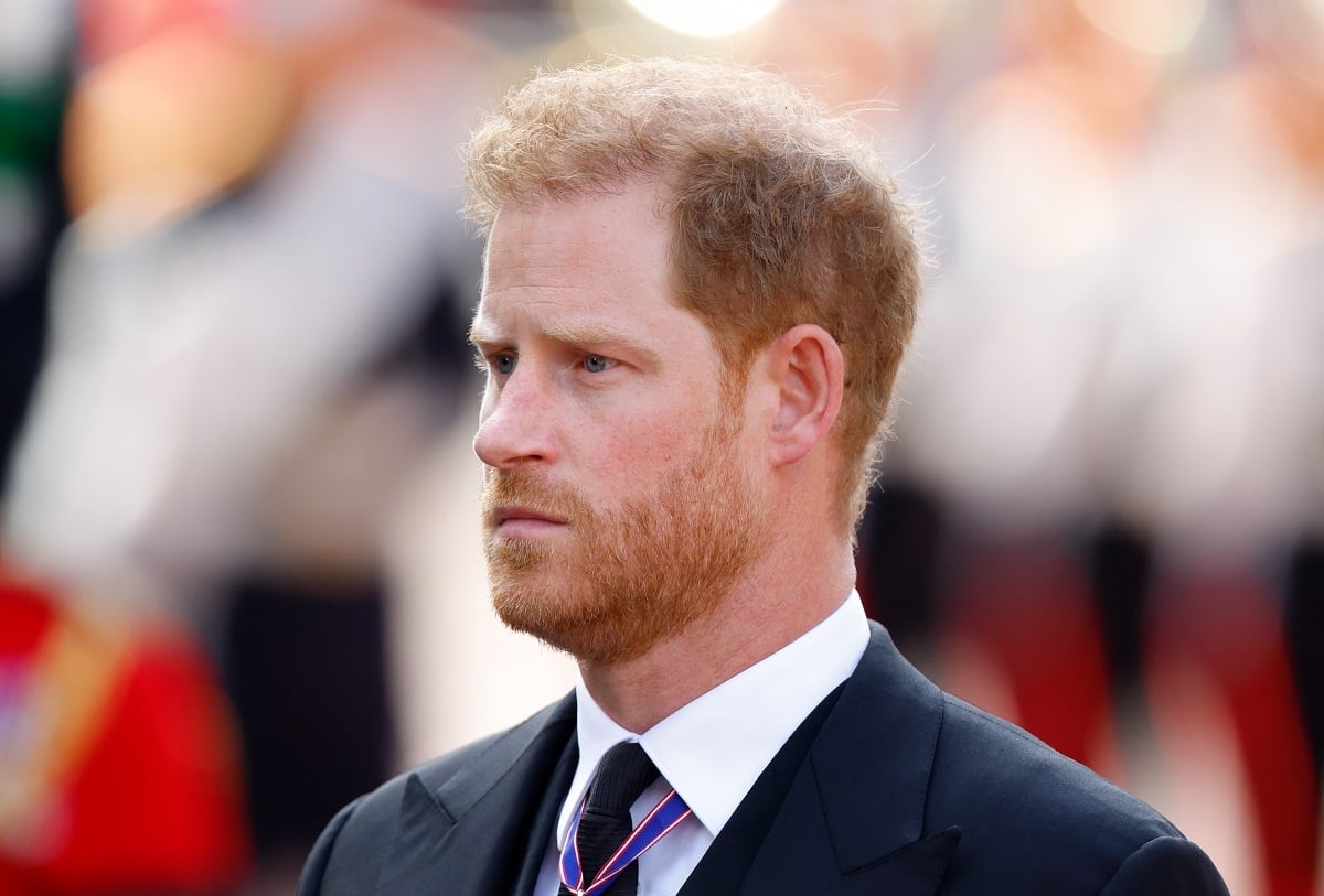 Prince Harry, who another prince believes is suffering since leaving the royal family, walks behind Queen Elizabeth II's coffin as it is transported on a gun carriage