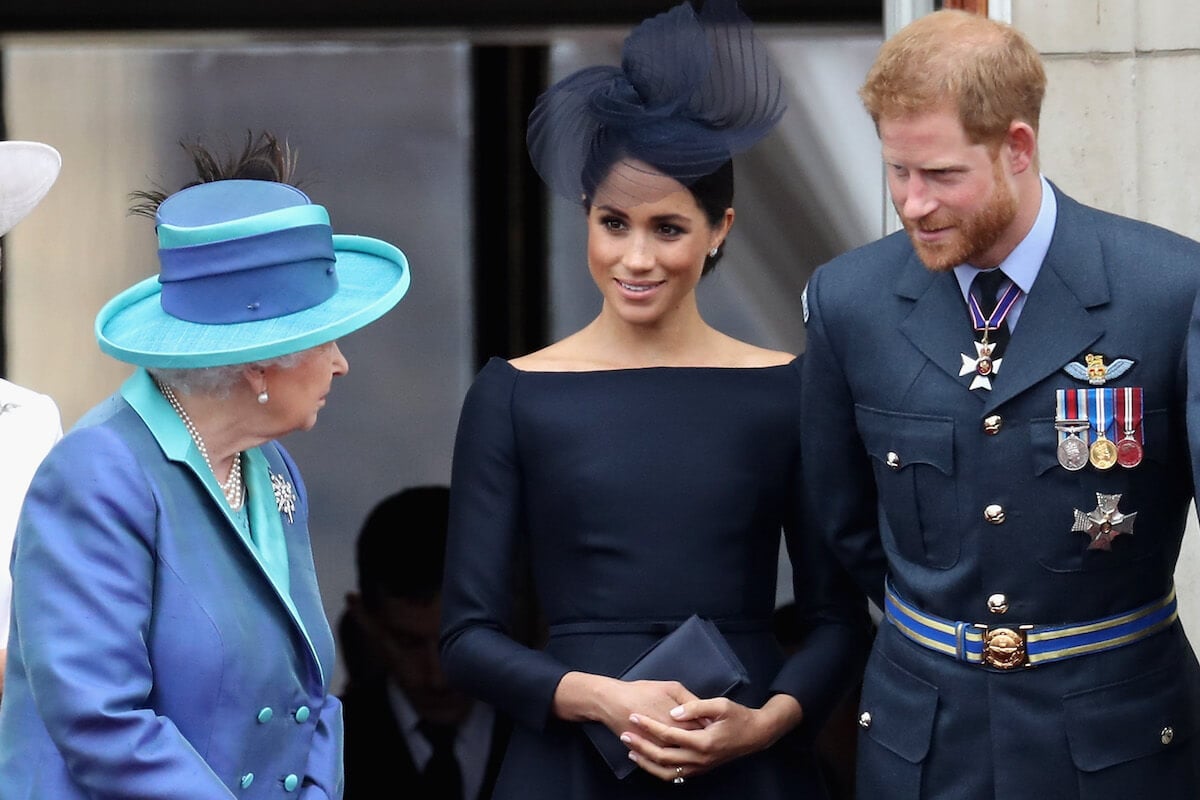 Prince Harry, whom Queen Elizabeth II 'warned' about Frogmore Cottage' before he and Meghan Markle toured the property, stands with Meghan Markle and Queen Elizabeth II