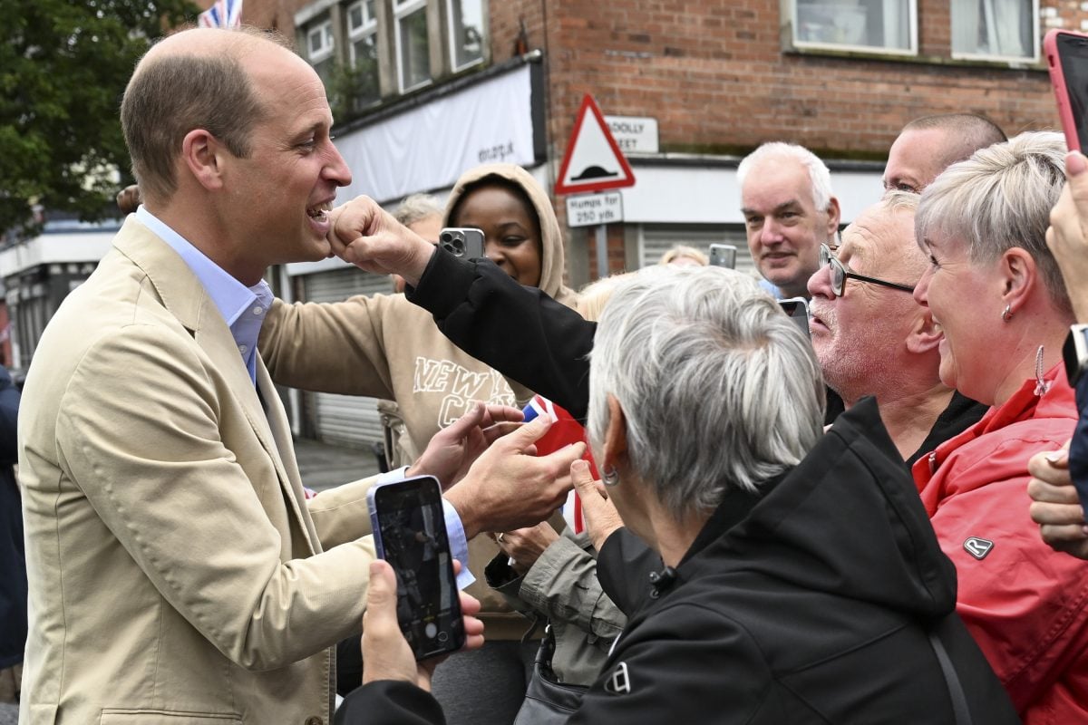 Prince William being jokinly greeted with a punch by a member of the public as he visits the East Belfast Mission as part of his U.K. tour to launch a project aimed at ending homelessness