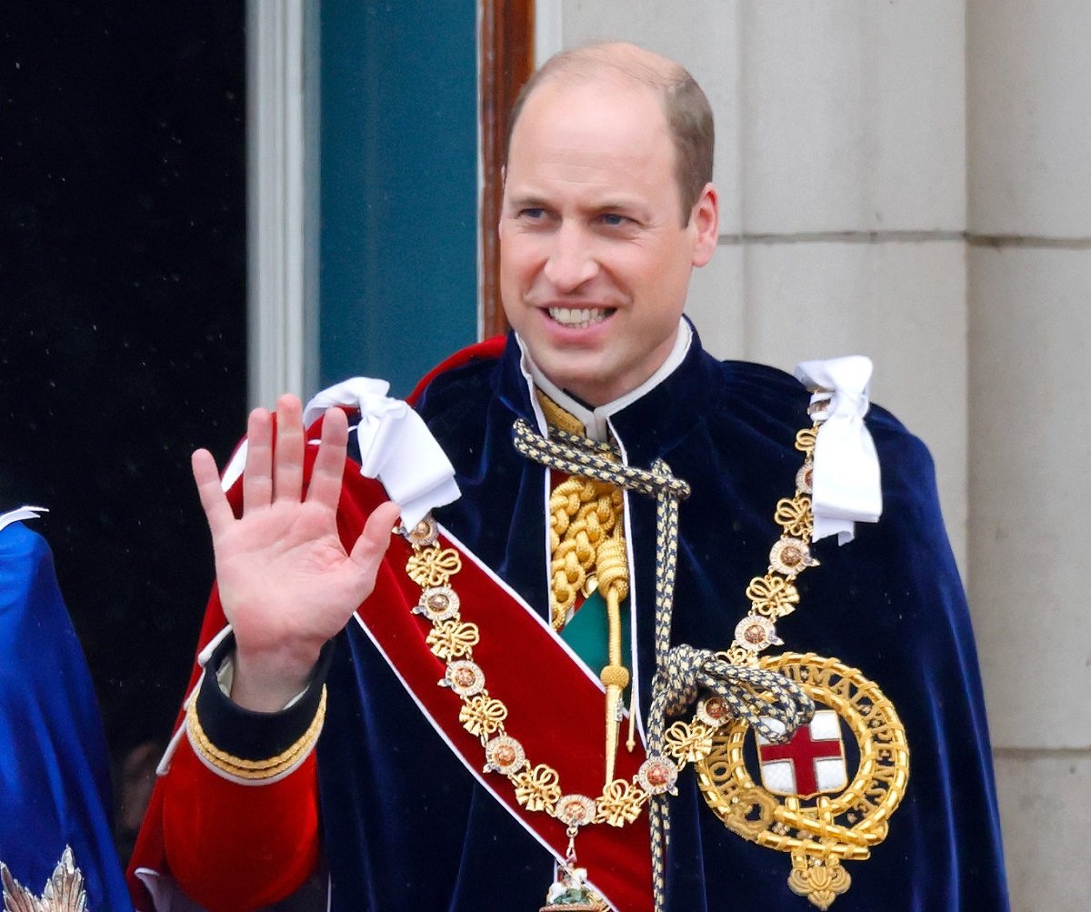 Prince William, who may allow two royals to return to duties once he's king, wearing the Mantle of the Order of the Garter while standing on the balcony of Buckingham Palace