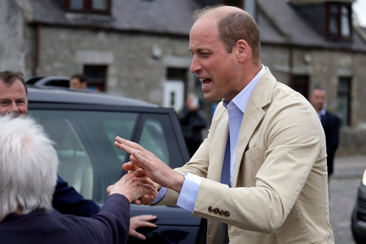 Prince William, who was jokingly punched in the face by a fan, meets members of the public following a visit for the launch of his homelessness programme