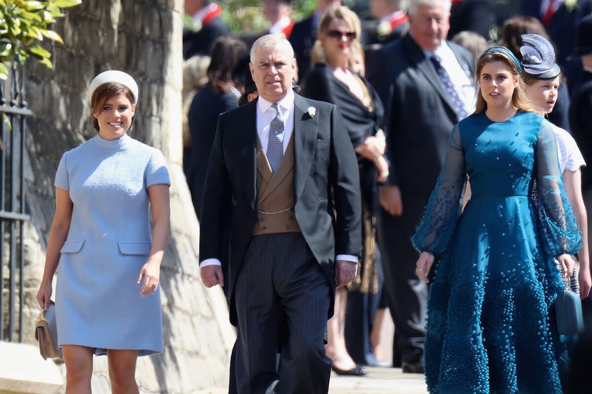Princess Beatrice and Eugenie, whom a royal author says would likely be unsuccessful trying to rehabilitate Prince Andrew's image, walk with their father