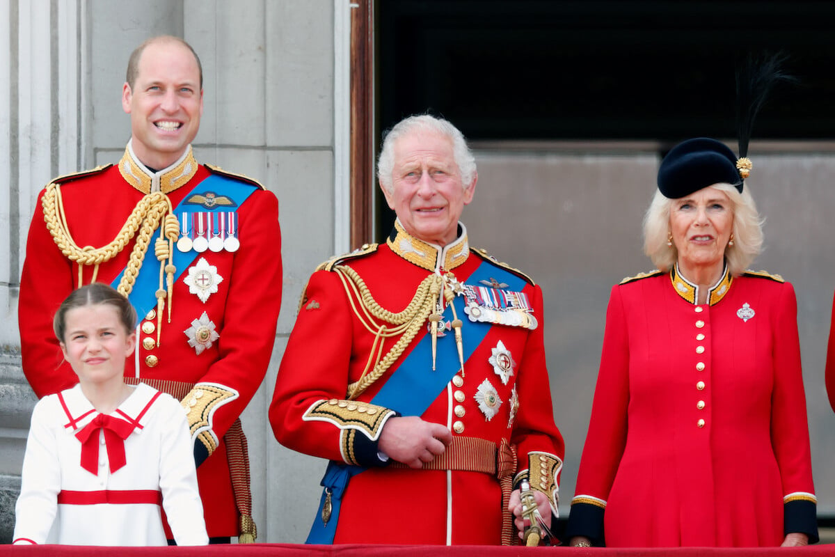Princess Charlotte, whom King Charles III apologized to on the Buckingham Palace balcony during Trooping the Colour, according to a lip reader, stands with Prince William, King Charles III, and Queen Camilla