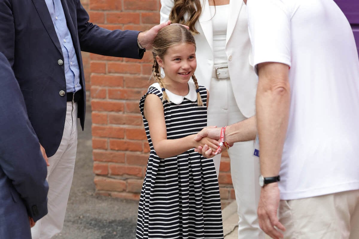 Princess Charlotte, who seemingly wiped her hand on her dress after a 2022 Commonwealth Games introduction, according to a body language expert, shakes hands