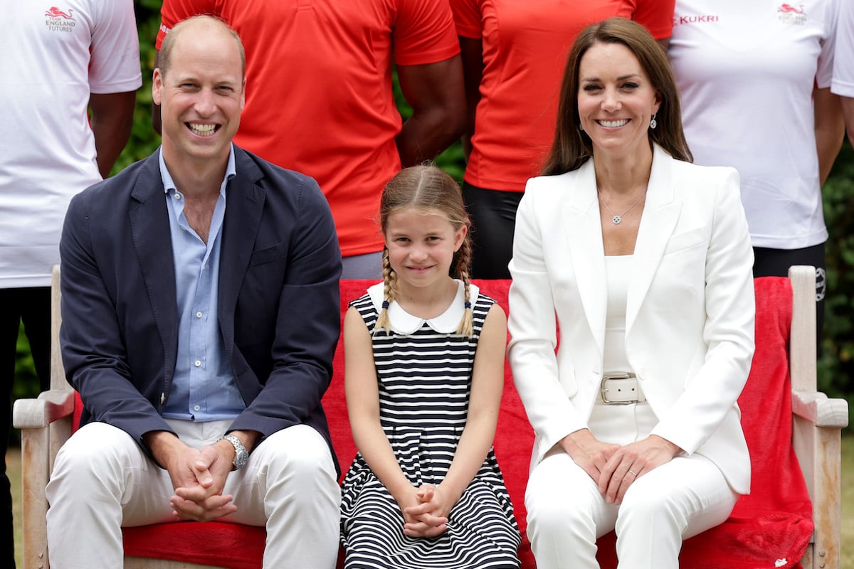 Princess Charlotte, who appeared to wipe her hand after shaking hands during the 2022 Commonwealth Games, per a body language expert, sits in between Prince William and Kate Middleton