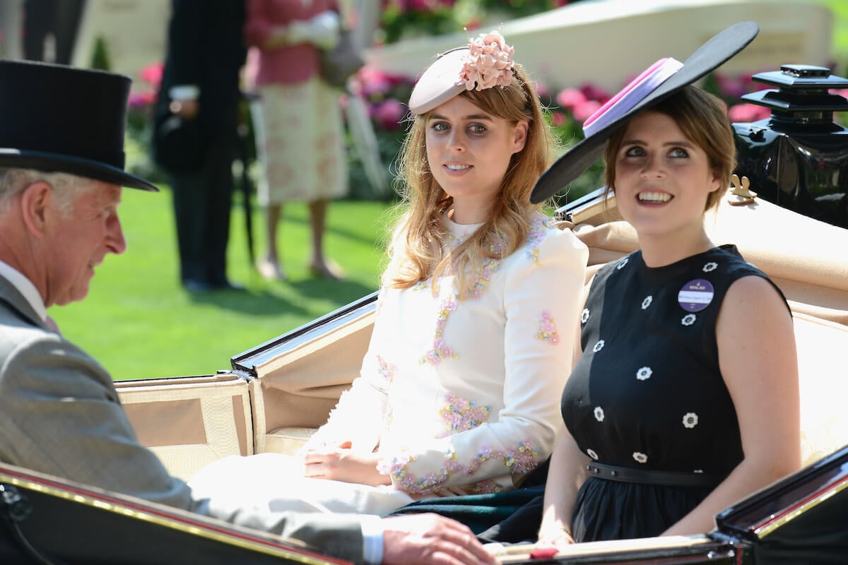 Princesses Beatrice and Eugenie, whom a royal commentator says it'd be 'better' if they remain non-working than becoming working royals in King Charles III's slimmed down monarchy, in a carriage with King Charles III