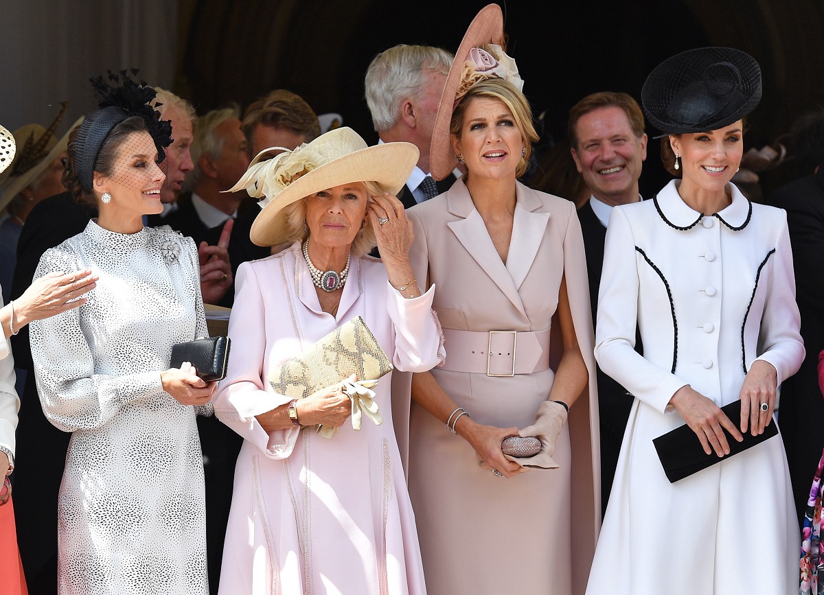 Queen Letizia, Camilla Parker Bowles (Queen Camilla)who a body language expert says sometimes looks 'irritated' and 'frosty' at royal events, Queen Maxima, and Kate Middleton attend the Order of the Garter service at St George's Chapel