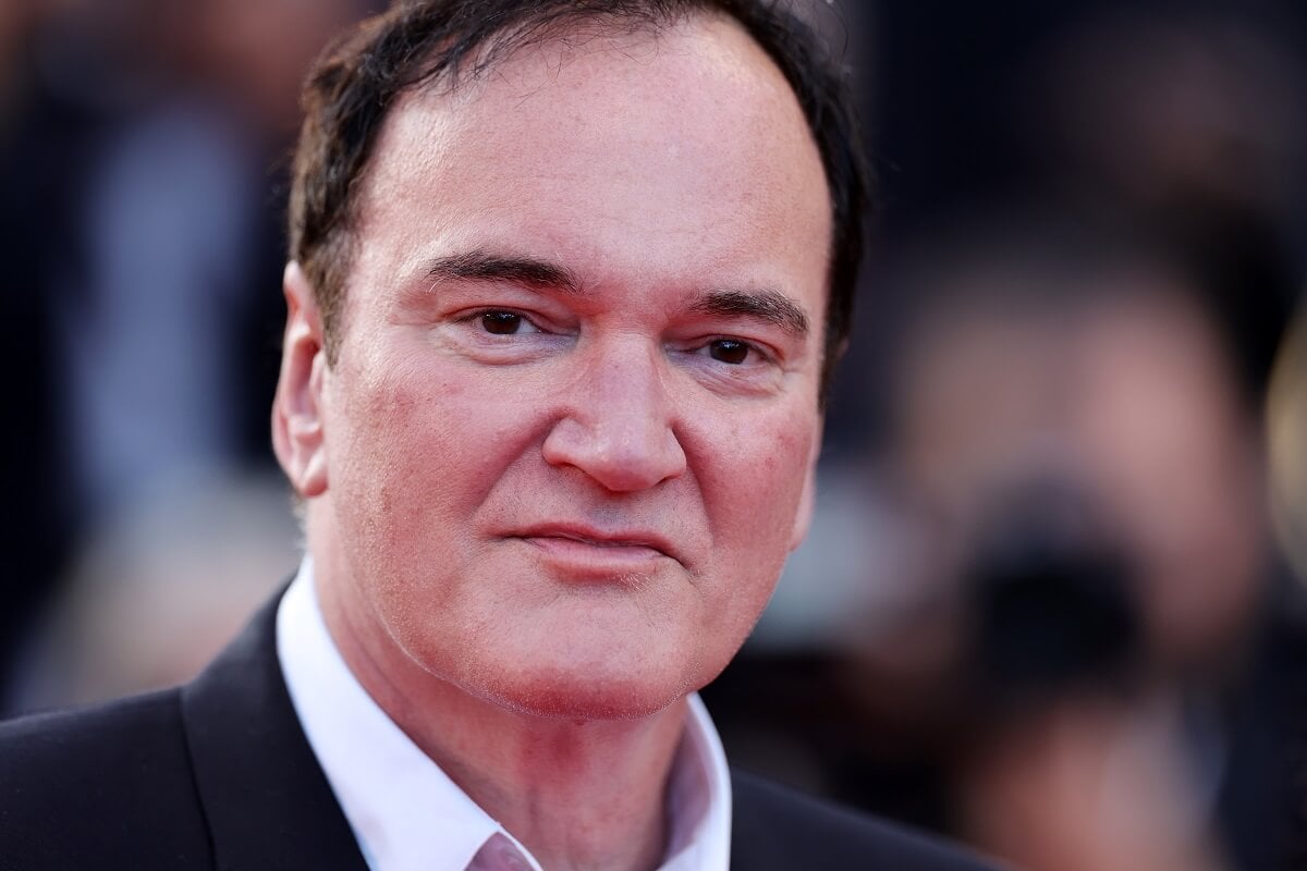 Quentin Tarantino posing while wearing a suit at a movie screening at the Cannes Film Festival.