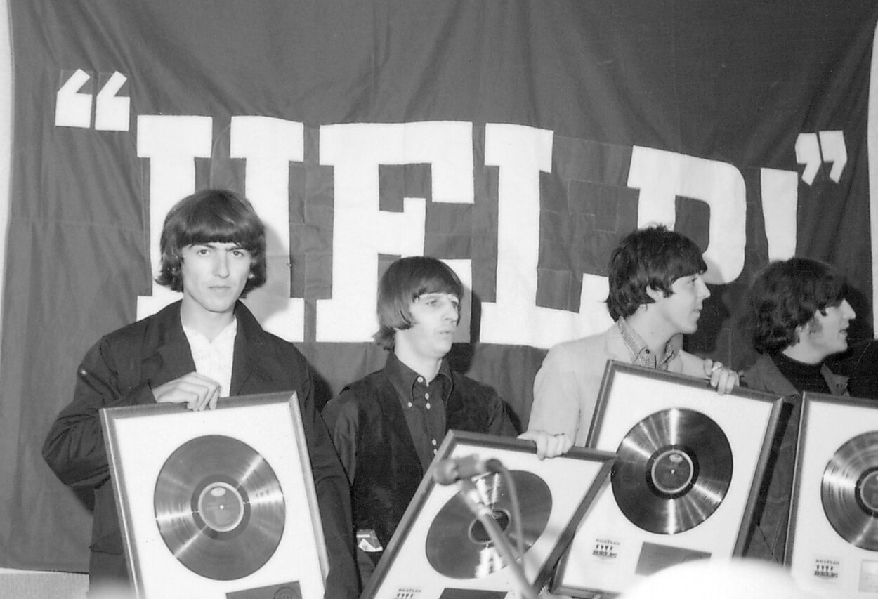Beatles members (from left) George Harrison, Ringo Starr, Paul McCartney, and John Lennon receive gold records for their song 'Help!' in August 1965.