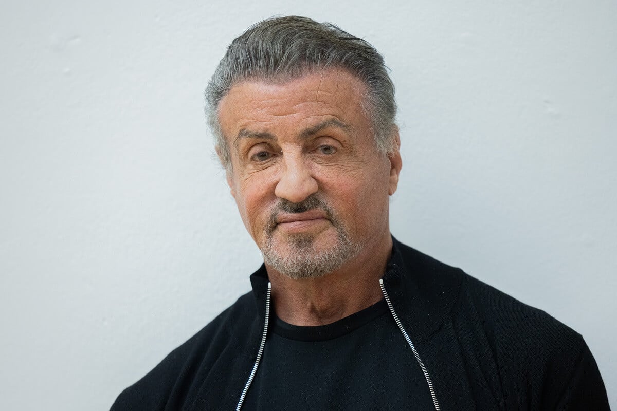 Sylvester Stallone posing in a black jacket at the Osthaus Museum.