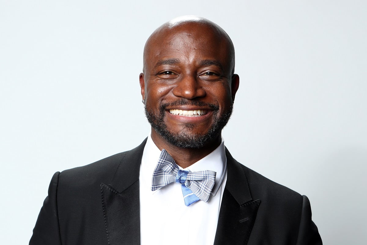 Taye Diggs posing in a suit at the The Elton John AIDS Foundation Academy Awards Viewing Party.
