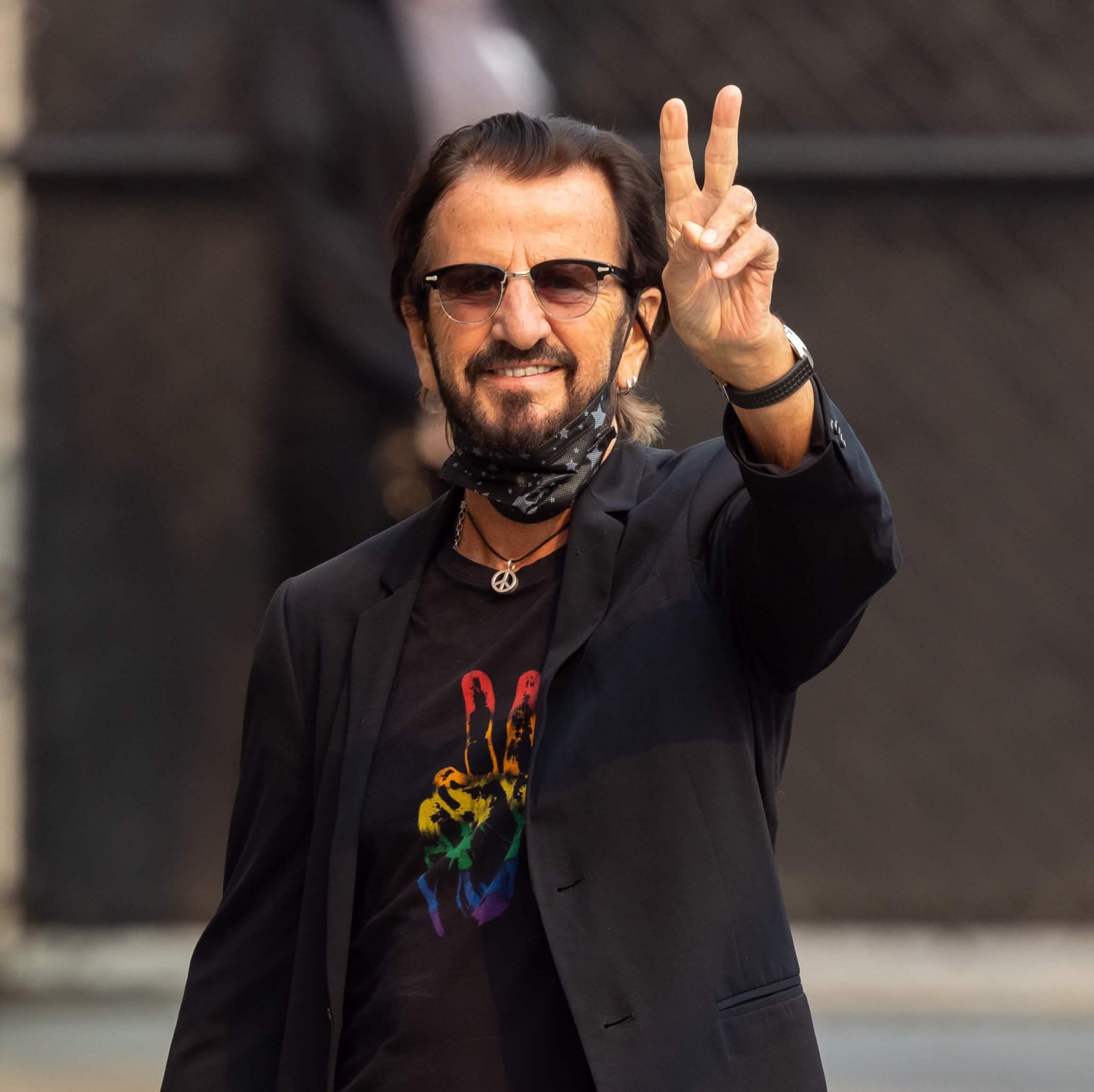 Ringo Starr making a peace sign