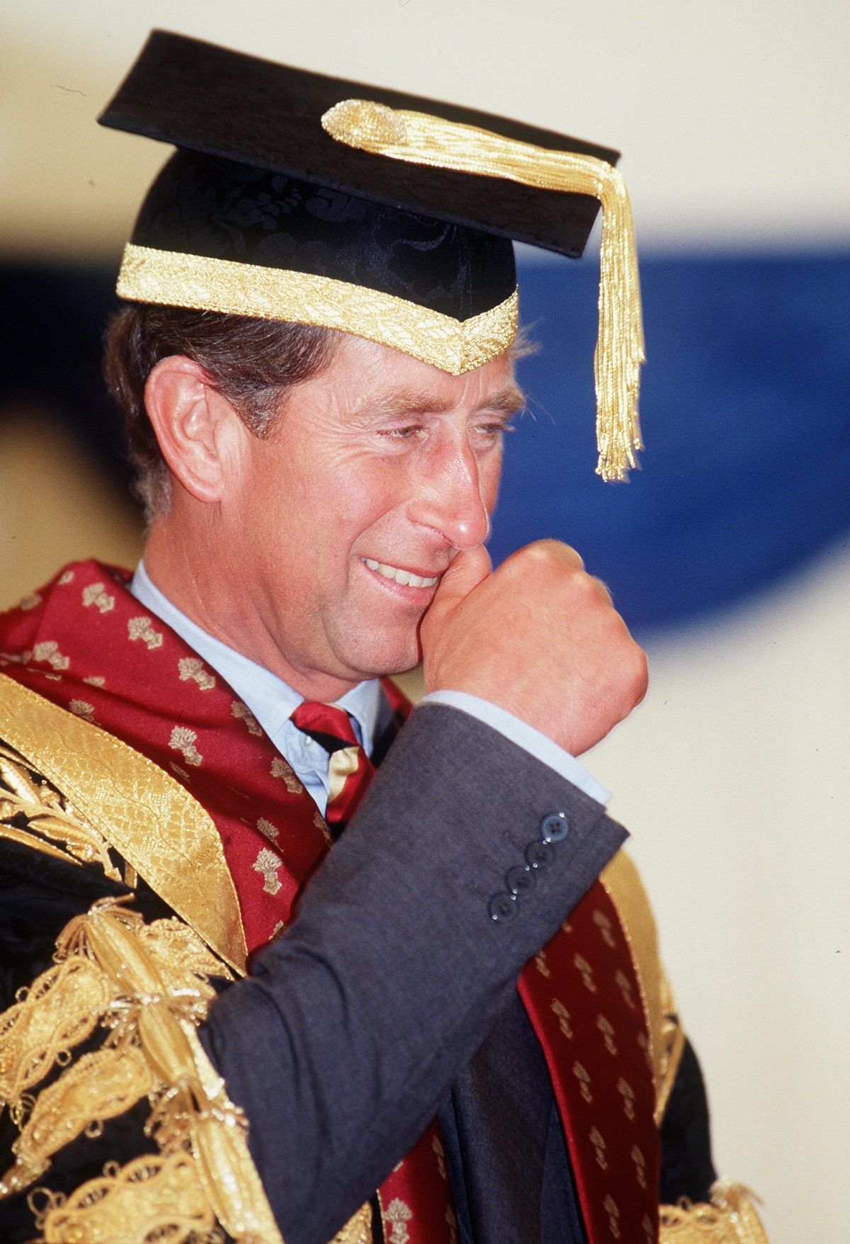 Then-Prince Charles scracthing his nose during a graduation ceremony at The Royal Agricultural College